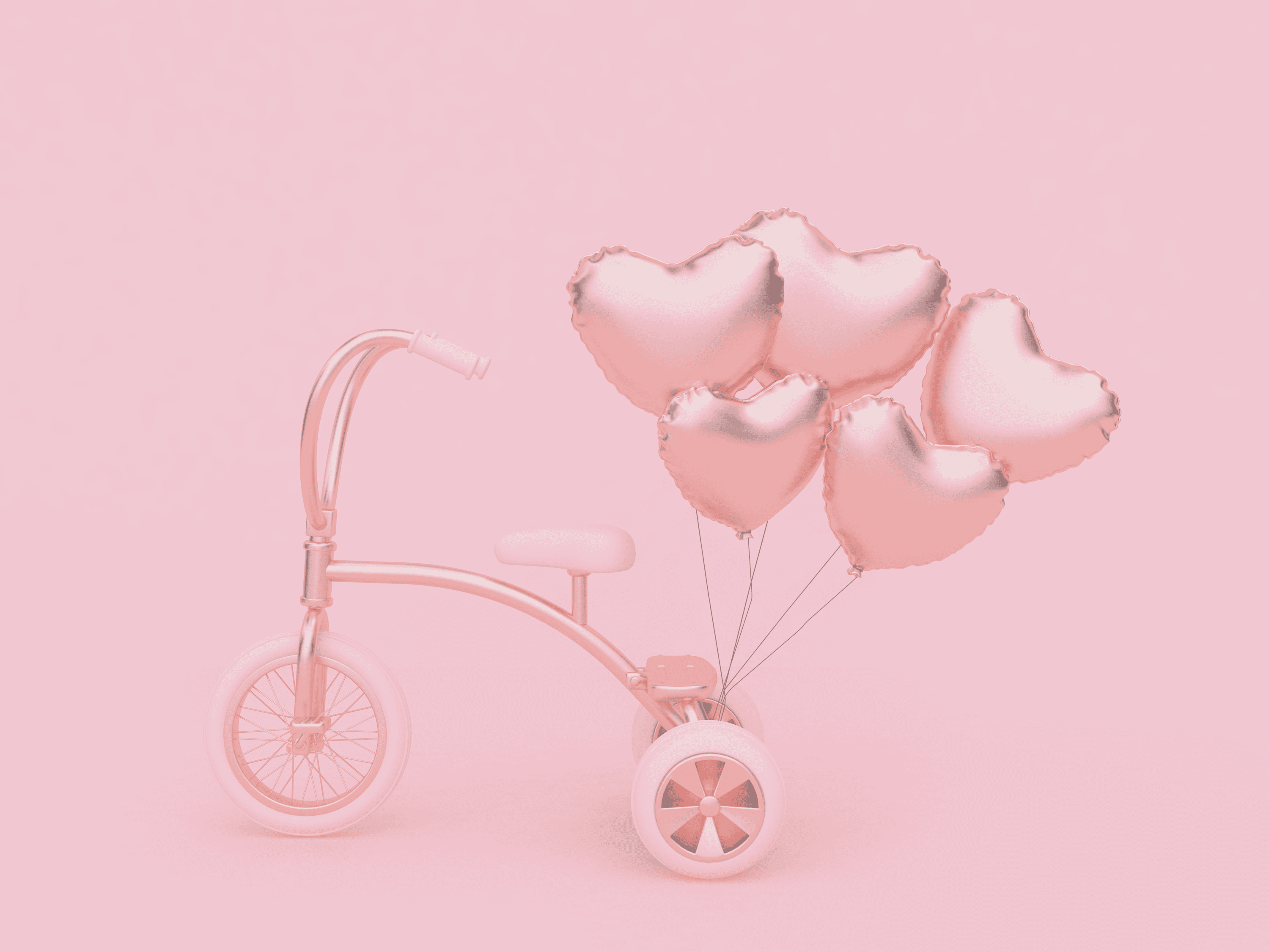 Heart-shaped balloons and a pink tricycle